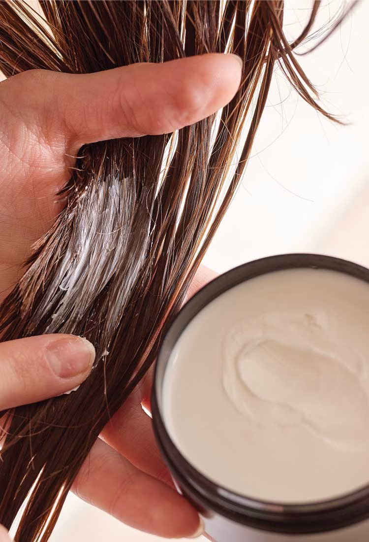 the hair playbook woman using conditioner